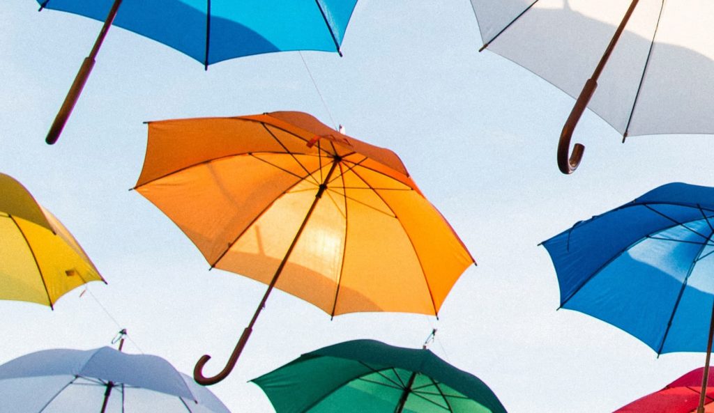 A group of colourful umbrellas hanging in the sky